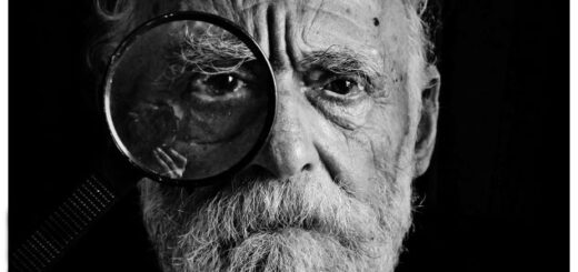 Image of older man with magnifying glass