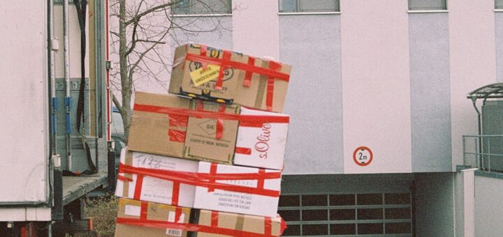Moving boxes on a dolly out in a yard