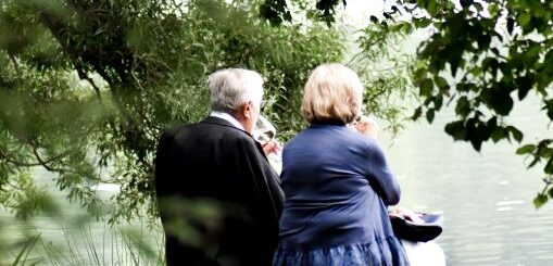 Older couple sitting on a park bench