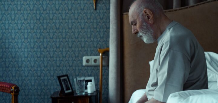 Lonely older man on side of bed