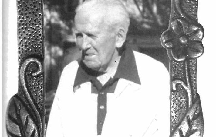 A vintage black and white photo of an old man in a gold shirt and sweater. He is my neighbor Joe taken from my book Minding Our Elders.